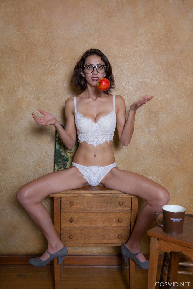 Nerdy girl in glasses undressing to pose nude with apple and ruler - #6