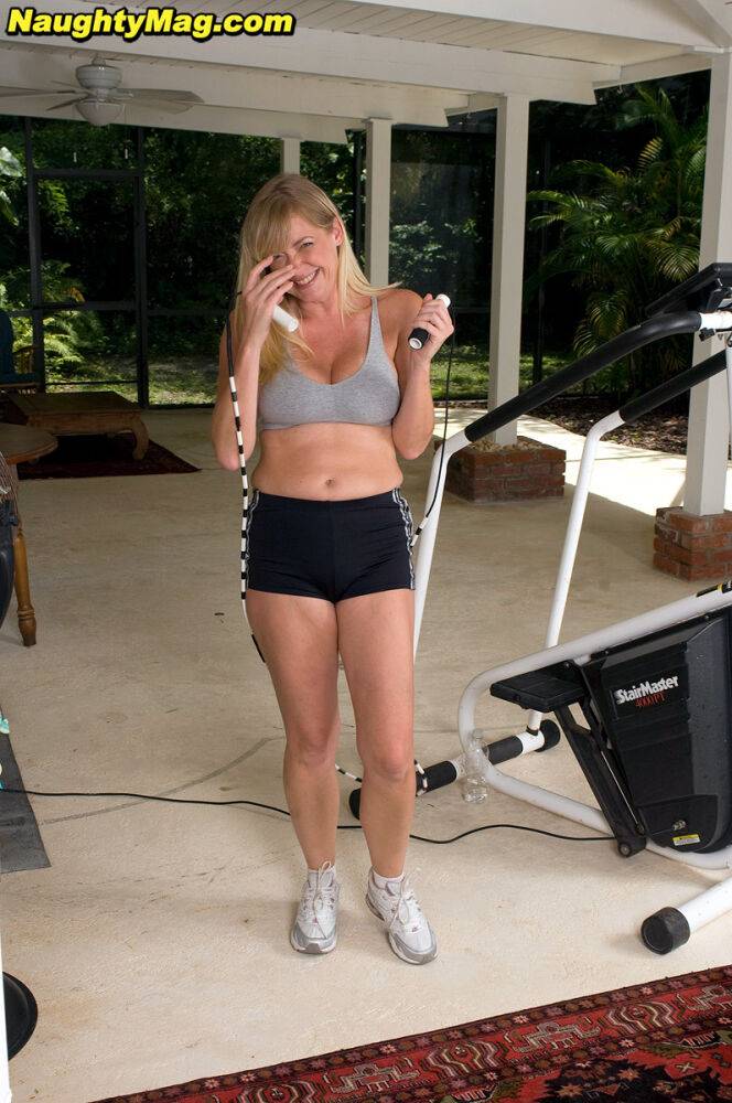 Busty blonde MILF exposes her big natural tits while working out at the gym - #2