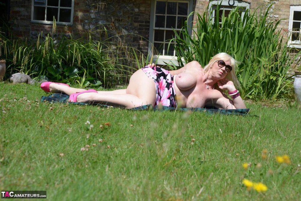 Overweight older blonde Melody displays her big naturals in a backyard setting - #10