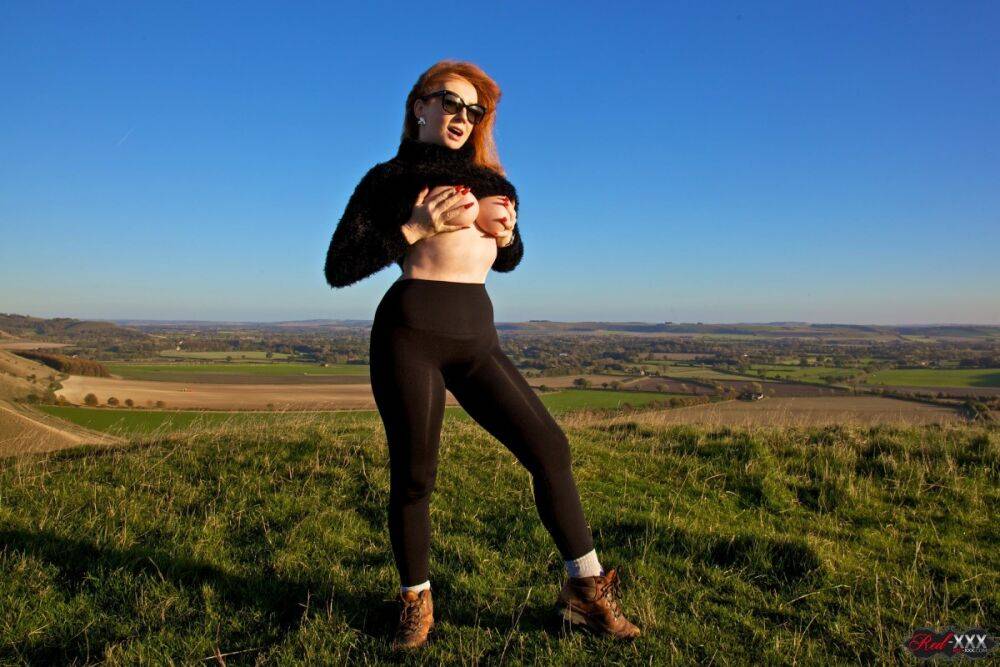 British woman with red hair uncovers her big boobs on a hill on a windy day - #3