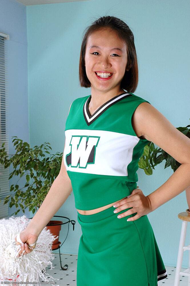 Amateur Asian freeing big tits and ass from beneath cheerleader uniform - #9