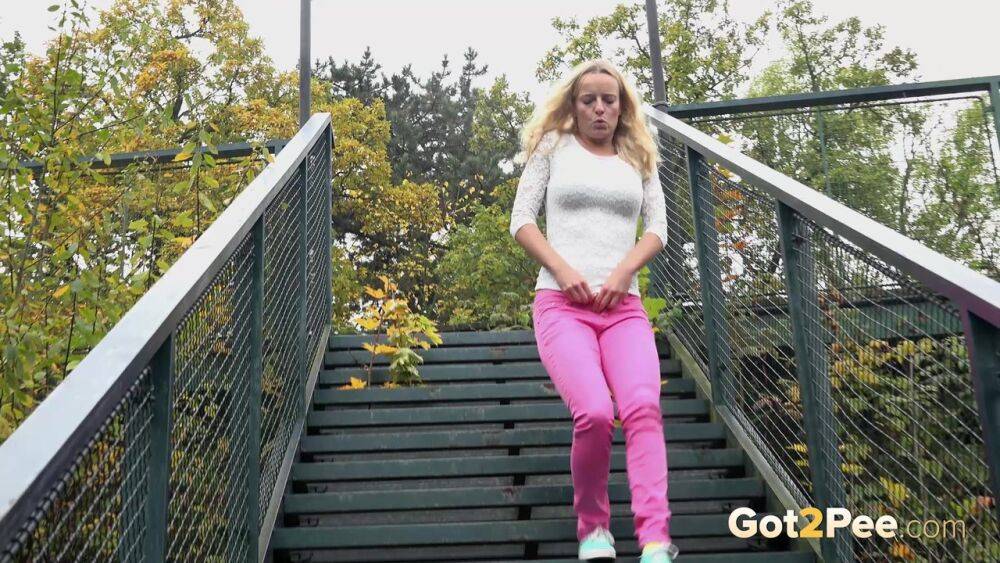 Blonde Victoria Pure pulling down her tight pants to pee on the bleachers - #11