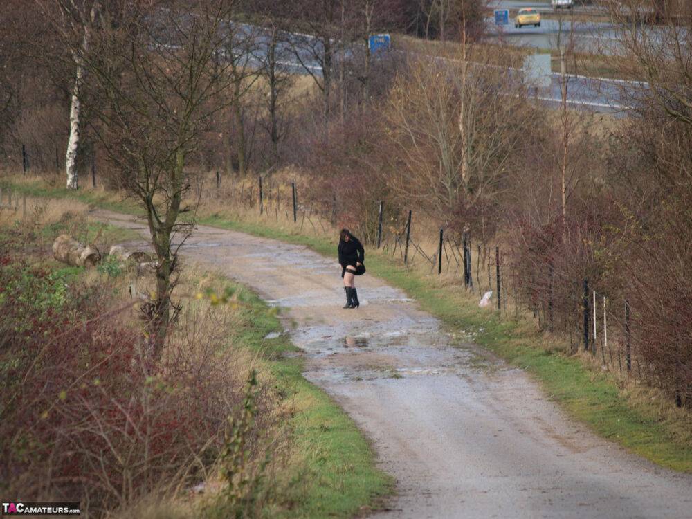 Overweight woman Roxy exposes herself while walking a path in black boots - #2