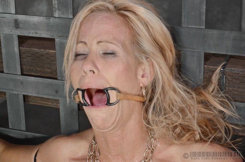 Mature blonde MILF Simone Sonay is subjected to oral abuse in a dungeon - #11