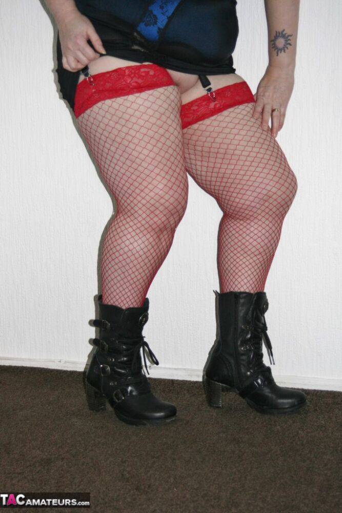 Mature BBW in red fishnet stockings & girdle spreading with big tits exposed - #11