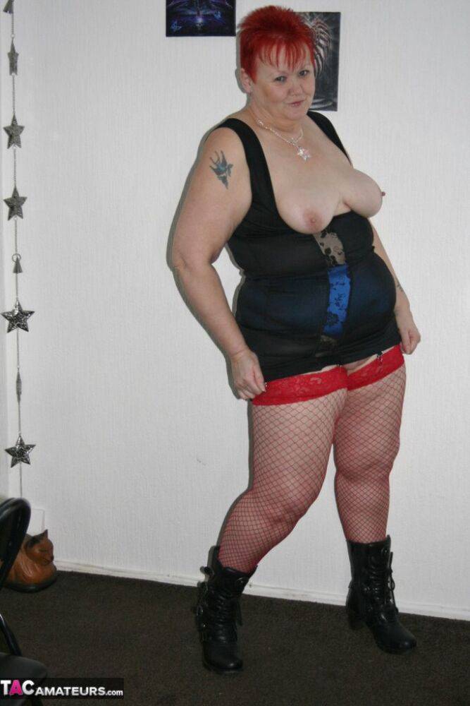 Mature BBW in red fishnet stockings & girdle spreading with big tits exposed | Photo: 4307280
