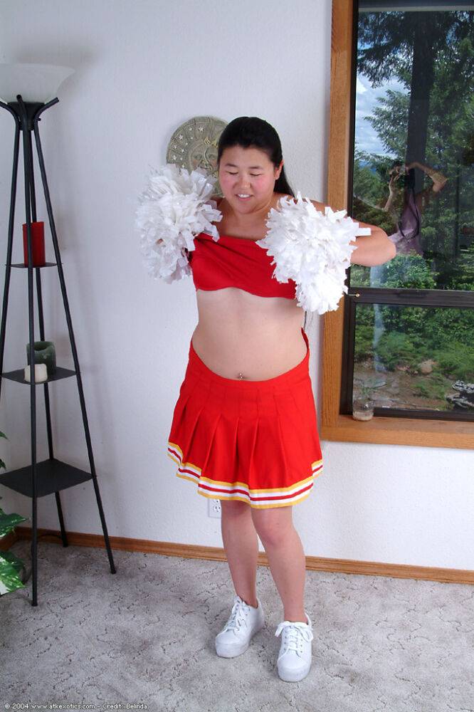 Chubby Asian first timer baring small boobs while shedding cheer uniform - #14