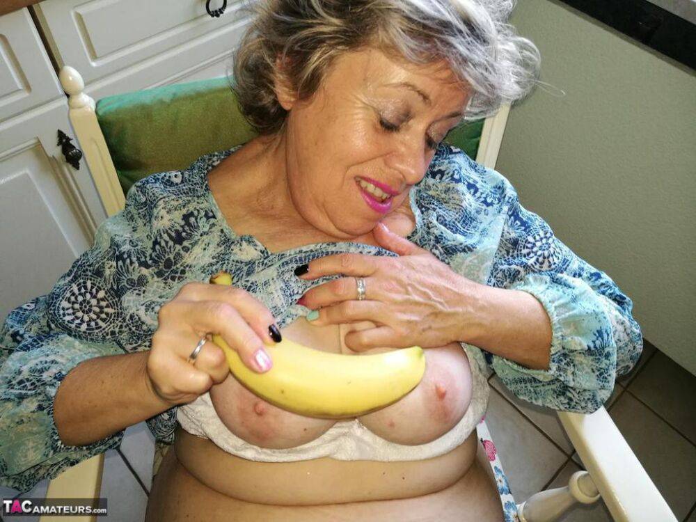 Horny granny Caro sticks a banana inside her natural pussy on kitchen chair - #11