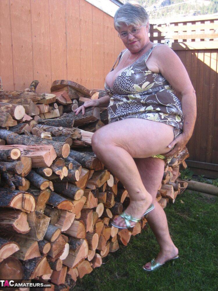 Brazen older granny strips off by the wood pile to show off BBW tits & big ass - #7