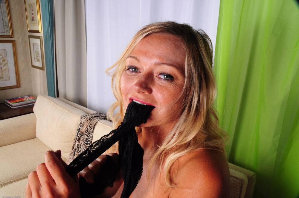 Mature woman Lexxi Lash sniffs her black panties after removing them - #9