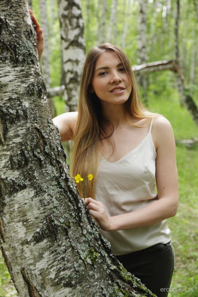 Long haired teen Kira T holds her firm tits before showing her pussy in woods - #7