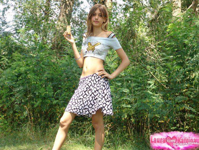 Shapely young teen in tiny t-shirt and short skirt posing outdoors - #3