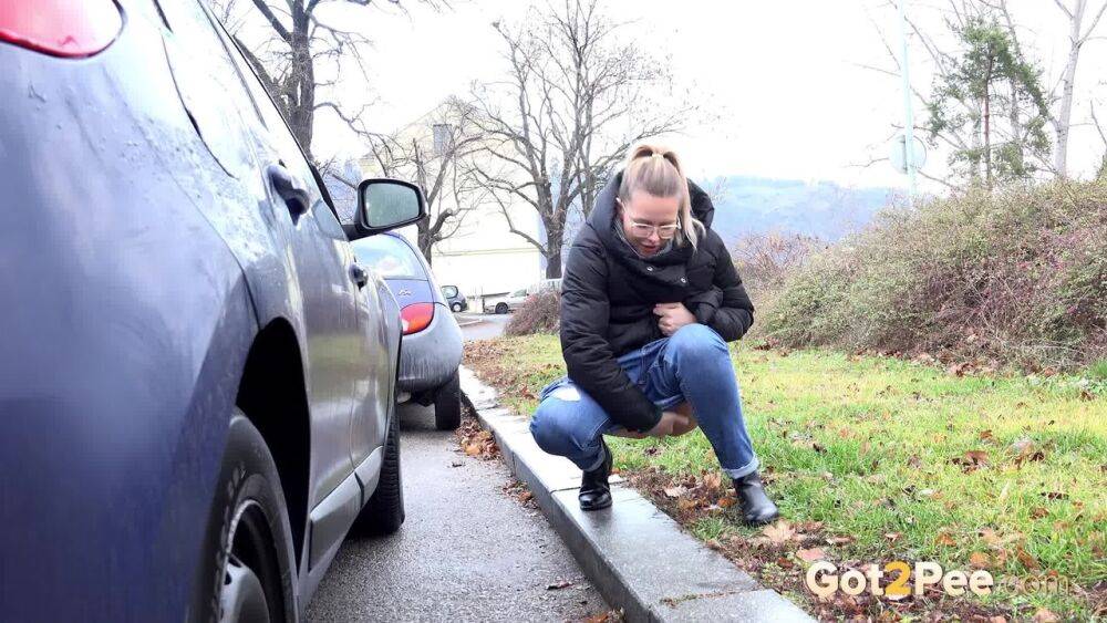 Blonde chick Nikki Dream squats for a pee behind vehicles on a road - #9