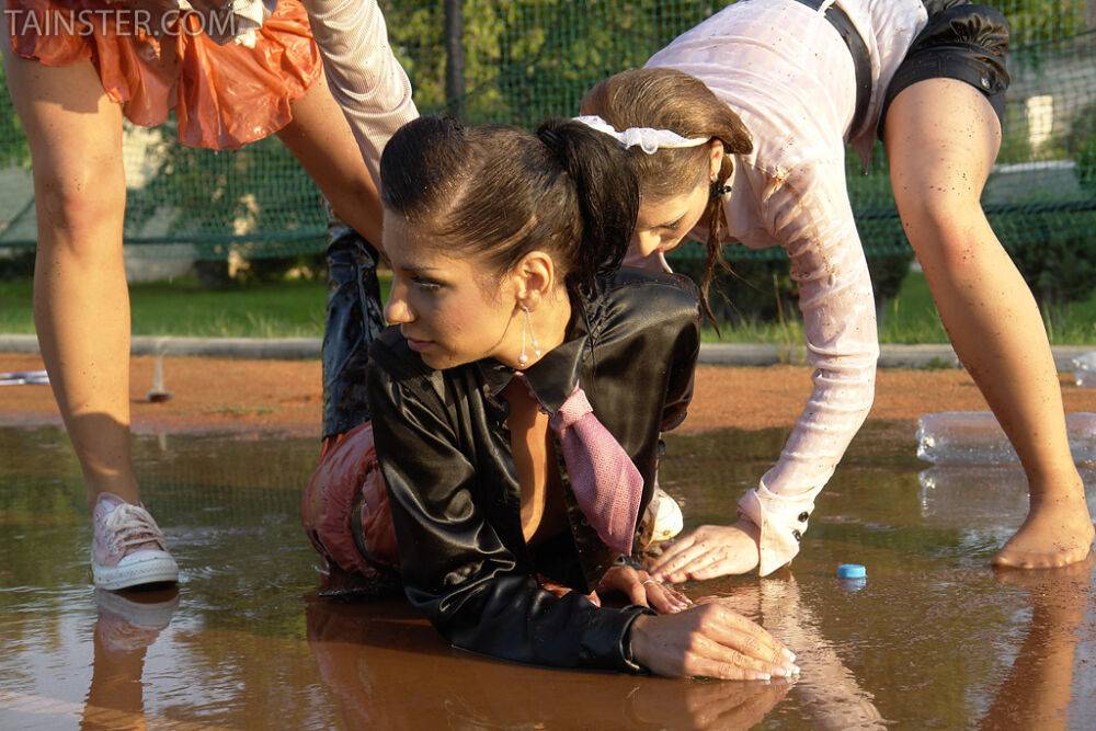 Seductive fully clothed fetish babes having some wet fun outdoor - #1