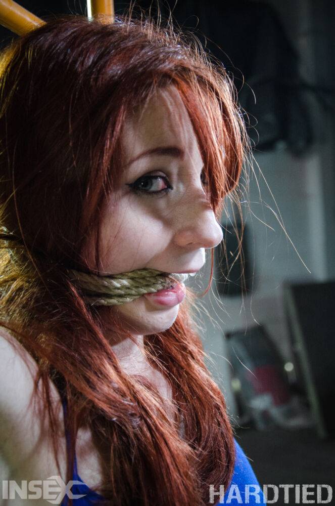 Redhead girl Violet Monroe is suspended by ropes in a dungeon setting - #2