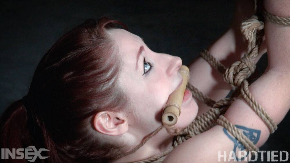 Redhead girl Violet Monroe is suspended by ropes in a dungeon setting - #5