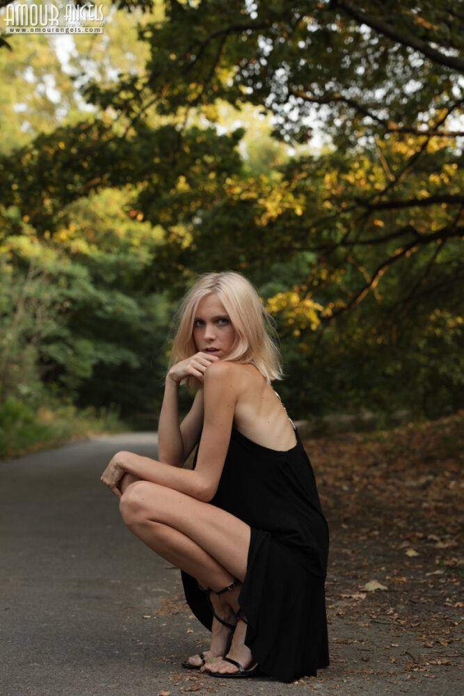 Skinny blonde teen Nora doffs a little black dress to get naked outdoors - #14