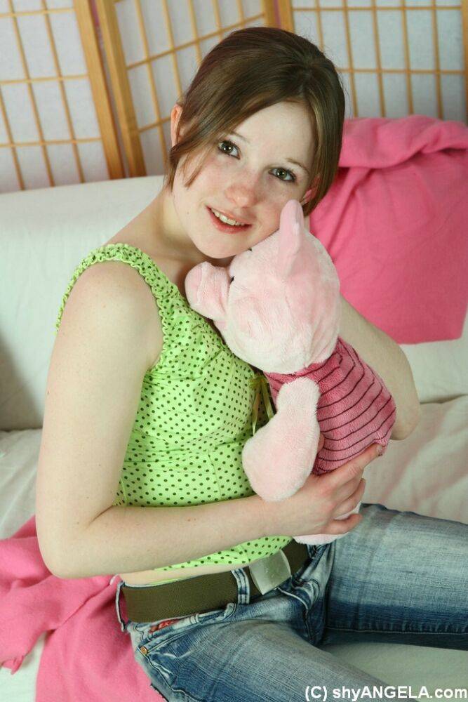 Sweet young girl Angela uncovers her tiny tits while playing with a plush toy - #1