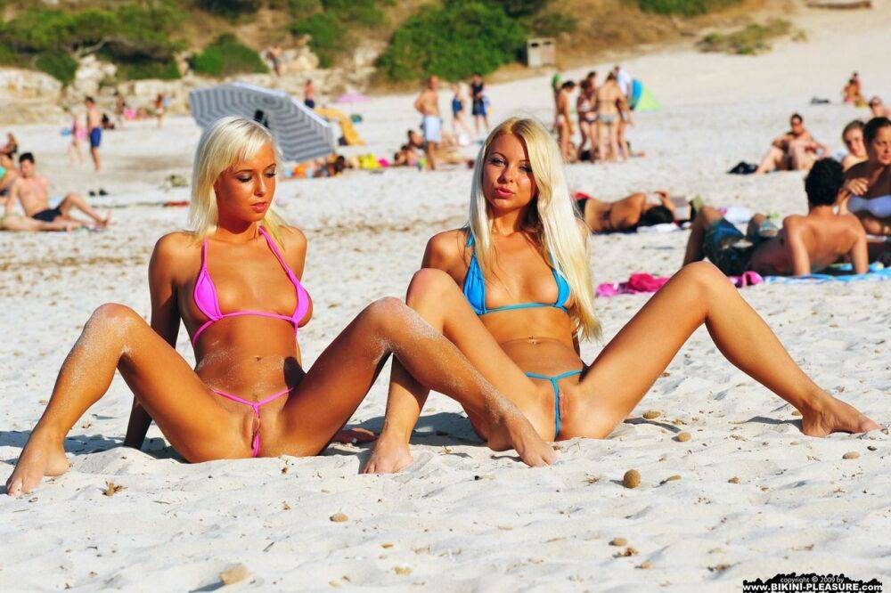 Blonde girls take off their bikinis while strolling on a public beach - #8