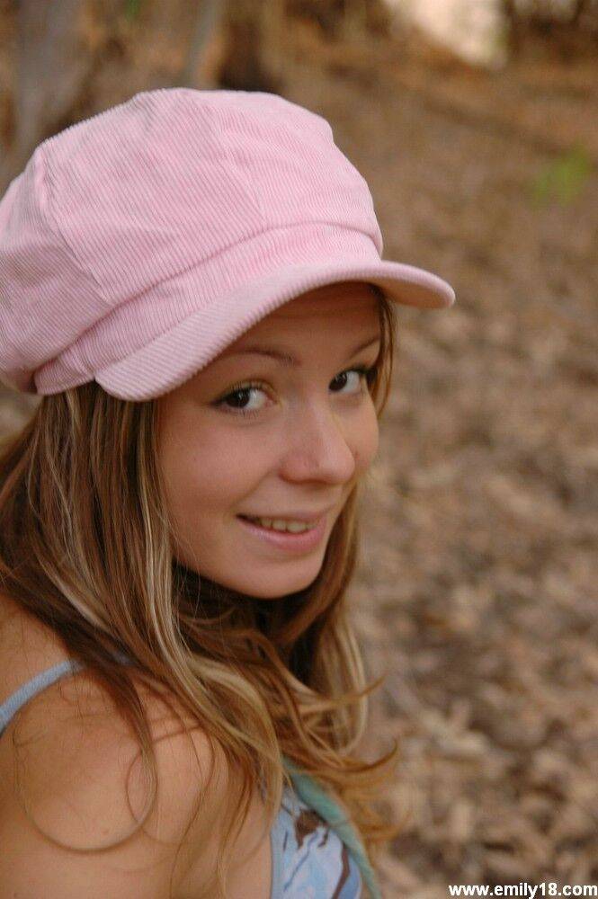 Adorable young girl sticks out her tongue while going topless in a forest - #11