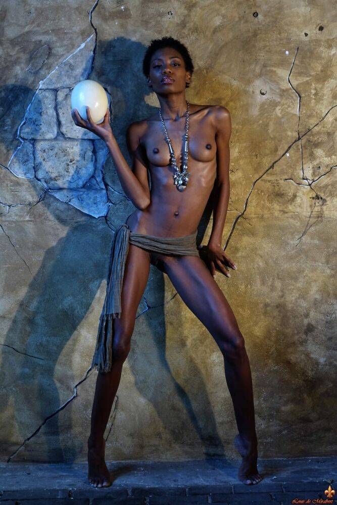 Dark skinned girl Jess holds a large egg while modeling butt naked - #4