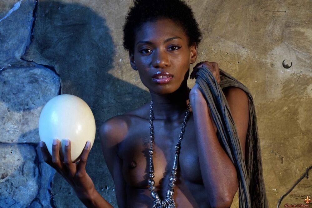 Dark skinned girl Jess holds a large egg while modeling butt naked - #9