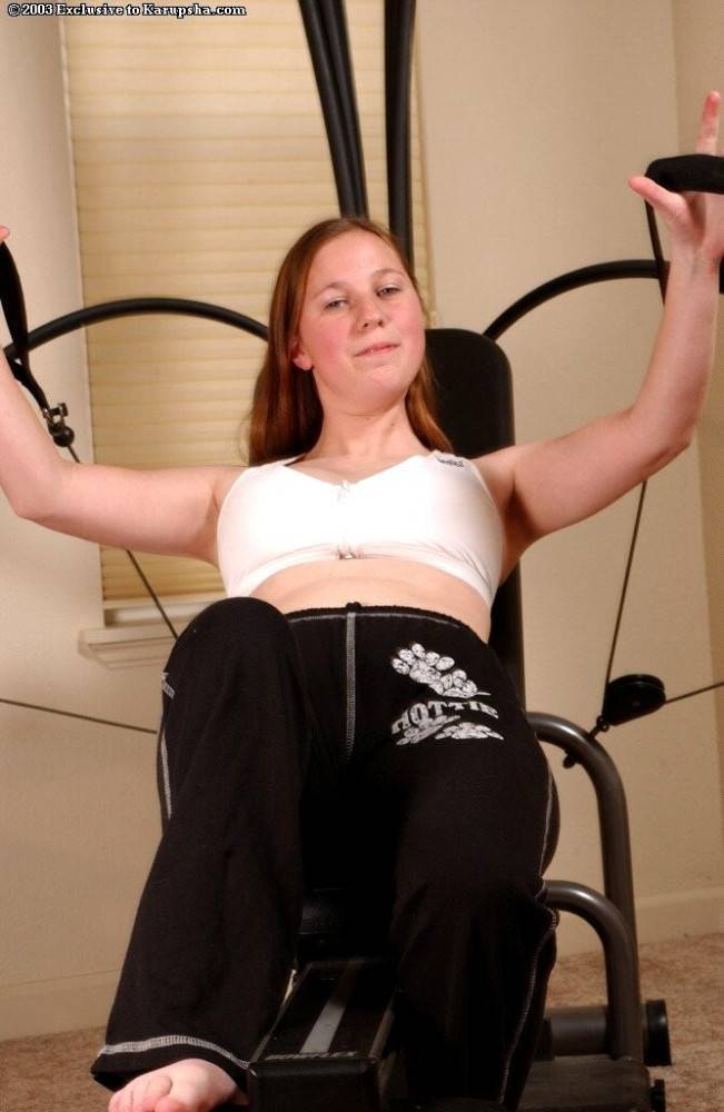 Hairy redhead teen ivy bell gets naked and works out on the bowflex! - #7