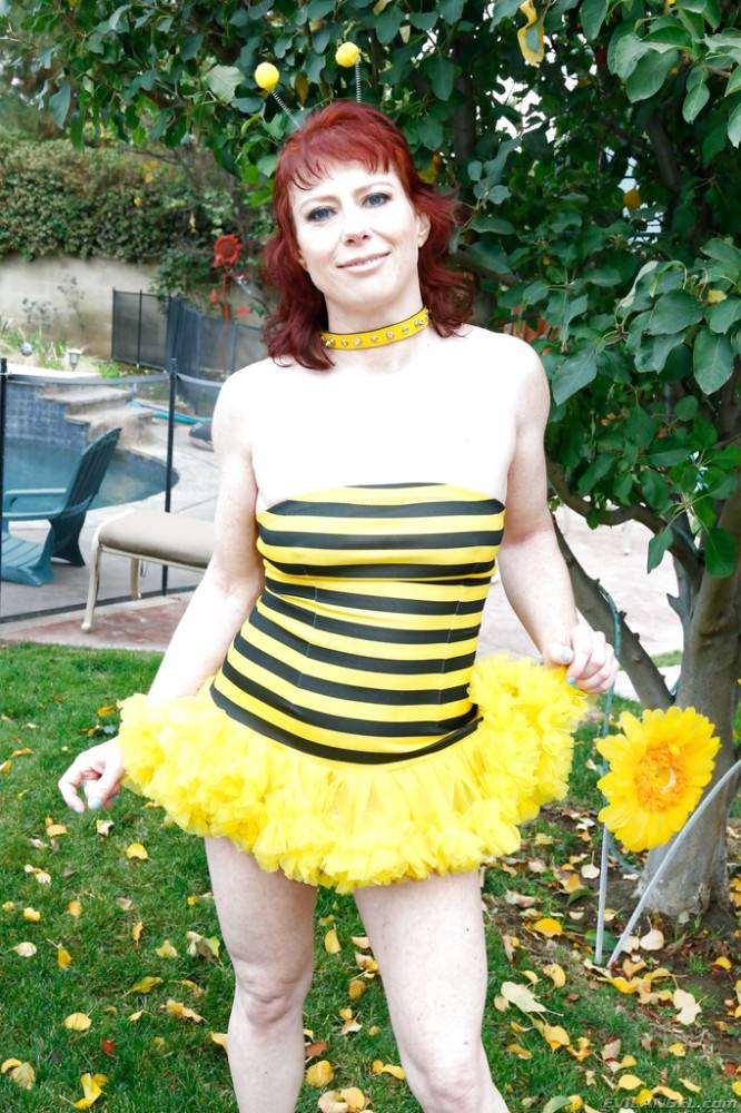 Hot american red-haired milf Amber Rayne in cosplay outfit revealing her butt and spreading her legs outdoor - #1