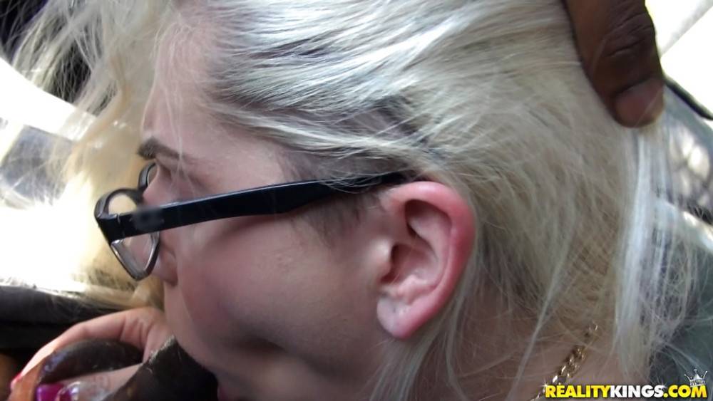 Stunning blonde Nikki Snow in glasses sucks on big black rod and enjoys a cum blast on her face in car - #13