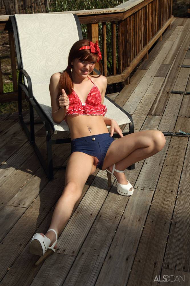 Stunning american young Alaura Lee in fancy shorts exhibiting small tits and toying outdoor - #5
