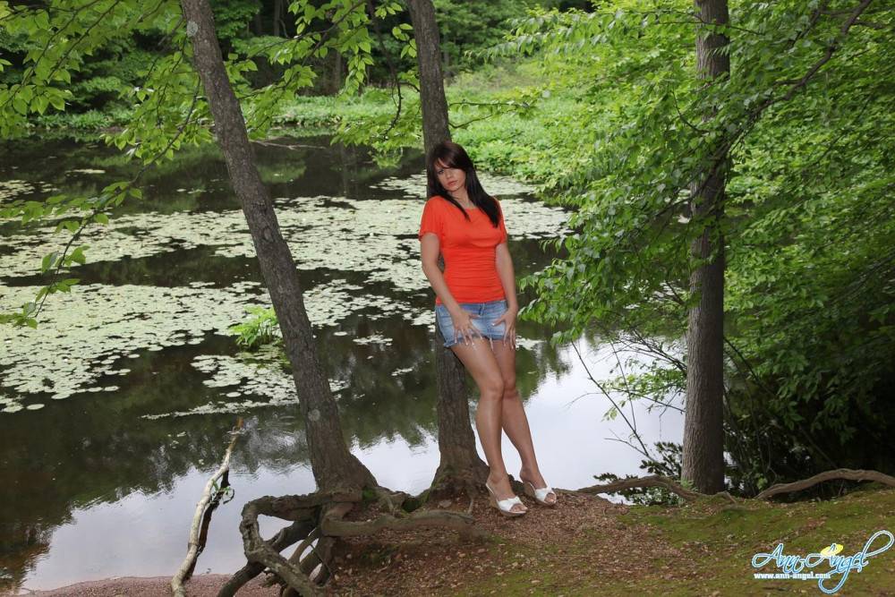 Sweet Ann Angel In Blue Jean Mini Skirt And Red T-shirt Spreads Poses On The Bank Of The River - #14