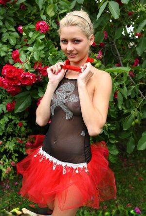 Cute blonde teen Buffy hikes up a tutu before masturbating in the back yard on nudesceleb.com