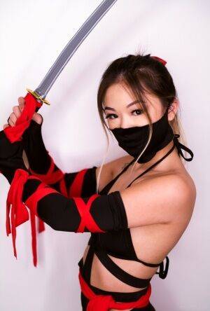 Petite Asian teen Lulu Chu wields a samurai sword before fucking on nudesceleb.com