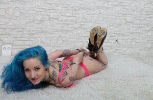 Tatted chick with blue hair is left hogtied in heels and her underwear on nudesceleb.com