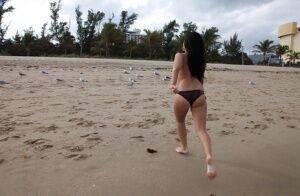 Naughty brunette amateur in bikini demonstrating her goods outdoor on nudesceleb.com