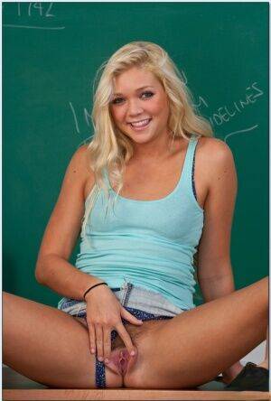 Cute college girl Jessie Andrews stripping in the class and spreading on nudesceleb.com