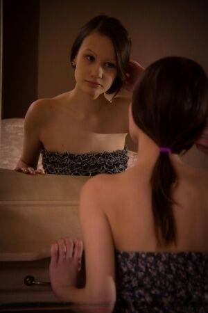 Brunette teen Anna B admires her smooth pussy in bedroom mirror on nudesceleb.com