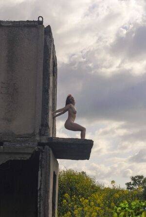 Natural redhead Elis B poses for a daring nude shoot in an derelict building on nudesceleb.com