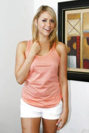 Blonde babe Kennedy Leigh posing fully clothed before exposing tiny tits on nudesceleb.com
