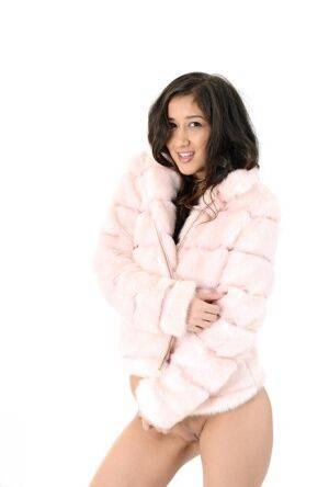 Brunette teen Darcia Lee doffs a fur coat and leggings before dildo riding on nudesceleb.com