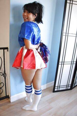 Tiny Asian cheerleader May Lee posing in cute uniform and socks on nudesceleb.com