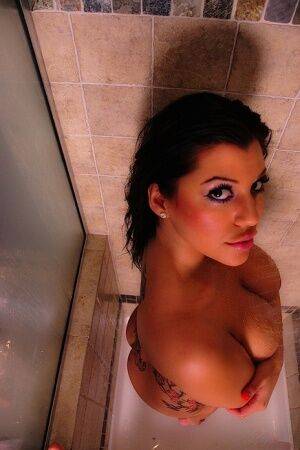 Tattooed amateur Briana Lee removes her bath towel before taking a shower on nudesceleb.com