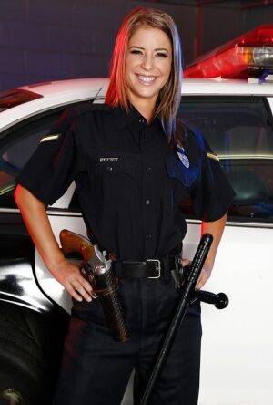 Sassy hottie in police uniform undressing and spreading her legs on nudesceleb.com