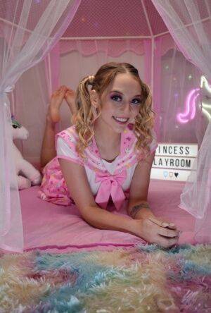 Cute teen Lily Larimar plays with her curly pigtails while getting naked on nudesceleb.com