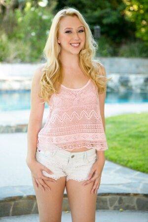 Cute blonde Samantha Rone stands naked after disrobing on a backyard walkway on nudesceleb.com