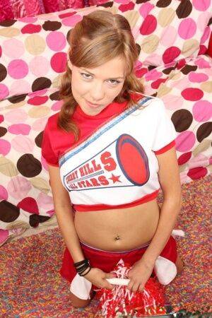 Teen cheerleader Nicole Ray shows off her perky tits and pink twat at halftime on nudesceleb.com