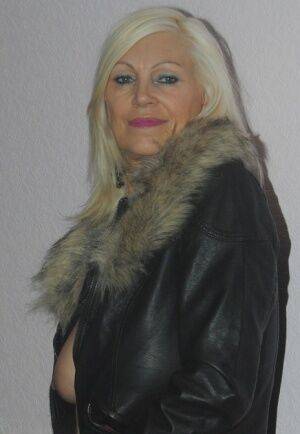 Older slut Platinum Blonde doffs leather jacket to reveal her huge saggy boobs on nudesceleb.com