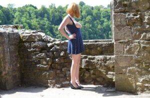 Redheaded amateur Barby Slut gets totally naked while wandering castle grounds on nudesceleb.com