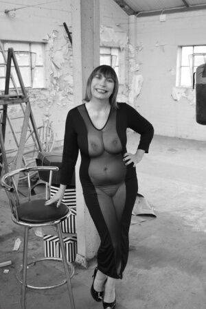 Middle-aged woman Barby Slut models a see-thru dress for a black-and-white gig on nudesceleb.com