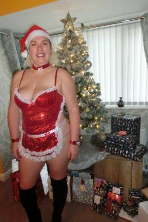 Busty blonde Barby masturbates her shaved pussy near the Christmas tree on nudesceleb.com